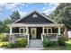 Inviting home with a covered front porch, stone accents, and lush landscaping at 109 St Marys St, Garner, NC 27529