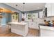 Bright kitchen features a center island, white cabinets, and stainless steel appliances at 109 St Marys St, Garner, NC 27529