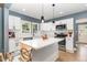 Modern kitchen with stainless steel appliances, an island, and white cabinetry at 109 St Marys St, Garner, NC 27529