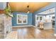Open concept living room showcases a brick fireplace, wood floors and bright lighting, adjacent to the kitchen at 109 St Marys St, Garner, NC 27529