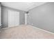 Neutral bedroom with grey walls, carpet, closet and white door at 10941 Pendragon Pl, Raleigh, NC 27614