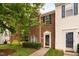 Charming brick townhome featuring a well-maintained lawn and mature landscaping at 10941 Pendragon Pl, Raleigh, NC 27614