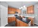 Kitchen with wooden cabinets, stainless steel appliances, and black countertops at 10941 Pendragon Pl, Raleigh, NC 27614