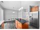 Well-equipped kitchen featuring stainless steel appliances, dark floors, and ample counter space at 10941 Pendragon Pl, Raleigh, NC 27614