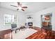 Bright living room with hardwood floors, fireplace, and open access to the kitchen at 10941 Pendragon Pl, Raleigh, NC 27614