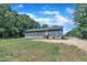 Rear view of the home showcasing the backyard and a large lawn at 1118 Oakridge Duncan Rd, Fuquay Varina, NC 27526