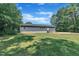 Rear view of the home showcasing the backyard and a large lawn at 1118 Oakridge Duncan Rd, Fuquay Varina, NC 27526