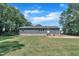 Rear view of the home showcasing the backyard and a large lawn at 1118 Oakridge Duncan Rd, Fuquay Varina, NC 27526