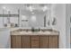 Bright bathroom featuring a double vanity with tan countertops and a large mirror at 1118 Oakridge Duncan Rd, Fuquay Varina, NC 27526