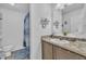 Clean bathroom with a single vanity, granite countertop, and shower with blue curtain at 1118 Oakridge Duncan Rd, Fuquay Varina, NC 27526