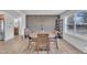 Bright dining room features a round table, wood accent wall, and large window at 1118 Oakridge Duncan Rd, Fuquay Varina, NC 27526