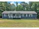 Charming single-story home with blue siding, a welcoming front porch, and a well-maintained lawn at 1118 Oakridge Duncan Rd, Fuquay Varina, NC 27526
