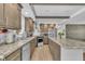 Well-lit kitchen with granite counters, tile backsplash, modern appliances and cabinets at 1118 Oakridge Duncan Rd, Fuquay Varina, NC 27526