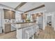 Bright kitchen featuring an island with breakfast bar and stainless steel refrigerator at 1118 Oakridge Duncan Rd, Fuquay Varina, NC 27526
