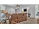 Spacious living room featuring reclining sofas and an adjacent kitchen space, perfect for entertaining guests at 1118 Oakridge Duncan Rd, Fuquay Varina, NC 27526