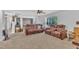 A bright living room with comfortable reclining sofas and an open view to the dining area at 1118 Oakridge Duncan Rd, Fuquay Varina, NC 27526