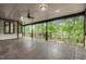 Expansive covered balcony with wooden flooring and railings offers serene views of lush greenery at 1164 Keith Hills Rd, Lillington, NC 27546