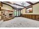 Basement features a stone fireplace, wood paneling, carpeting, and French doors to the outside at 1164 Keith Hills Rd, Lillington, NC 27546