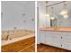 Dual view of bathroom with tub and vanity with unique hanging lighting fixtures at 1164 Keith Hills Rd, Lillington, NC 27546