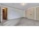 A spacious bedroom with multiple closets, neutral carpet, and tan trim at 1164 Keith Hills Rd, Lillington, NC 27546