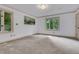 A neutral bedroom with large windows offering natural light and exterior views at 1164 Keith Hills Rd, Lillington, NC 27546