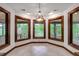 Bright dining area with a lake view and wooden trim windows at 1164 Keith Hills Rd, Lillington, NC 27546