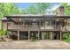 Spacious home with multi-level deck, brick accents, and lush landscaping at 1164 Keith Hills Rd, Lillington, NC 27546