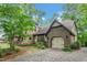 Charming Tudor home with stone accents, garage, and a patterned stone driveway at 1164 Keith Hills Rd, Lillington, NC 27546