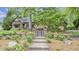 Beautifully landscaped front entrance with a brick walkway and decorative iron gate at 1164 Keith Hills Rd, Lillington, NC 27546