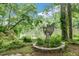 Beautiful garden with angel statue overlooking tranquil water views, enhancing the outdoor space at 1164 Keith Hills Rd, Lillington, NC 27546