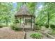 Charming gazebo surrounded by lush greenery offers a peaceful retreat in a serene outdoor setting at 1164 Keith Hills Rd, Lillington, NC 27546