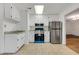 Kitchen with stainless steel appliances, white cabinets, and neutral countertops at 1164 Keith Hills Rd, Lillington, NC 27546