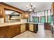 Cozy kitchen with wood cabinets, tile flooring, and views into an adjacent room at 1164 Keith Hills Rd, Lillington, NC 27546