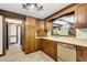 Well-lit kitchen featuring wooden cabinets, tile floor, and views to an adjacent room at 1164 Keith Hills Rd, Lillington, NC 27546