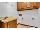 Functional laundry area featuring a vintage sink and classic cabinets at 1164 Keith Hills Rd, Lillington, NC 27546