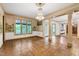 Spacious living room with hardwood floors, decorative columns, large windows and chandelier at 1164 Keith Hills Rd, Lillington, NC 27546
