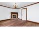 Bright room featuring a decorative fireplace and hardwood flooring at 1164 Keith Hills Rd, Lillington, NC 27546