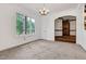 Bright living room with neutral carpet, large windows offering scenic views, and an ornate chandelier at 1164 Keith Hills Rd, Lillington, NC 27546