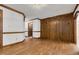 Living room features wood paneling, hardwood floors, and a glimpse into an adjacent room at 1164 Keith Hills Rd, Lillington, NC 27546