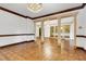 Large living room featuring columns, hardwood floors and a stunning chandelier at 1164 Keith Hills Rd, Lillington, NC 27546