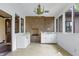 Charming sunroom with brick accent wall, white cabinets and ample natural light at 1164 Keith Hills Rd, Lillington, NC 27546