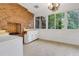 Bright sunroom with brick fireplace, white cabinets and large windows offering scenic views at 1164 Keith Hills Rd, Lillington, NC 27546