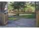 A fully fenced backyard features mature trees and a gazebo at 119 W Vernon Ave, Wake Forest, NC 27587