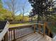 A backyard features a wooden deck, a well-maintained lawn, and mature trees at 119 W Vernon Ave, Wake Forest, NC 27587