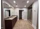 Bathroom featuring double sinks, granite counters and a tiled shower at 119 W Vernon Ave, Wake Forest, NC 27587
