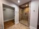 Bathroom featuring glass enclosed tiled shower, and a walk-in closet at 119 W Vernon Ave, Wake Forest, NC 27587