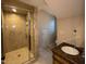 Bathroom features a glass-enclosed tile shower and modern vanity at 119 W Vernon Ave, Wake Forest, NC 27587
