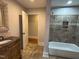 Bathroom featuring a tiled shower, bathtub, and a decorative vanity at 119 W Vernon Ave, Wake Forest, NC 27587