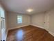 Comfortable bedroom with hardwood floors, natural light, and a closet at 119 W Vernon Ave, Wake Forest, NC 27587