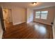 Spacious bedroom with hardwood floors, natural light, and neutral paint at 119 W Vernon Ave, Wake Forest, NC 27587